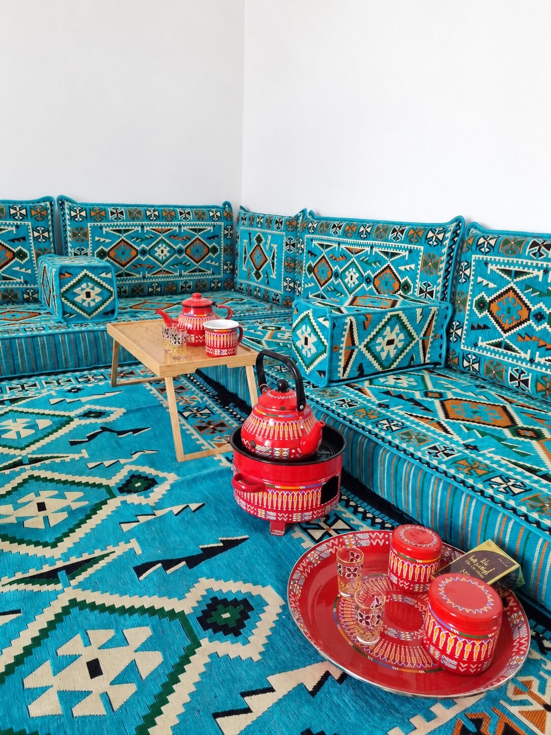 Red tea glasses on the turquoise majlis