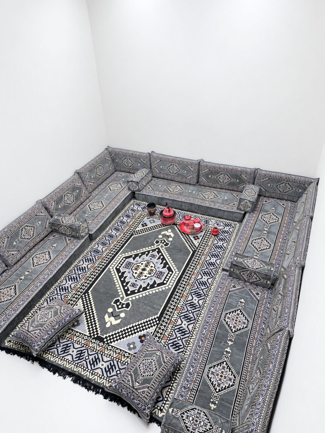 Khaima silver grey Sahrawi majlis around a white room with a matching grey rug