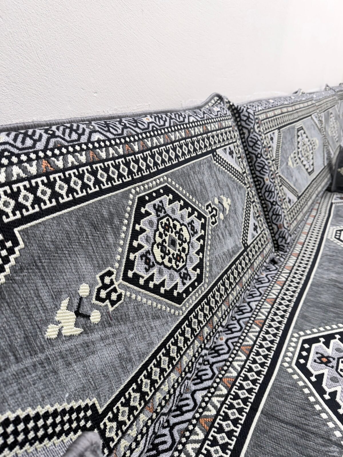 Close-up of the grey Sahrawi fabric with black and ivory motifs