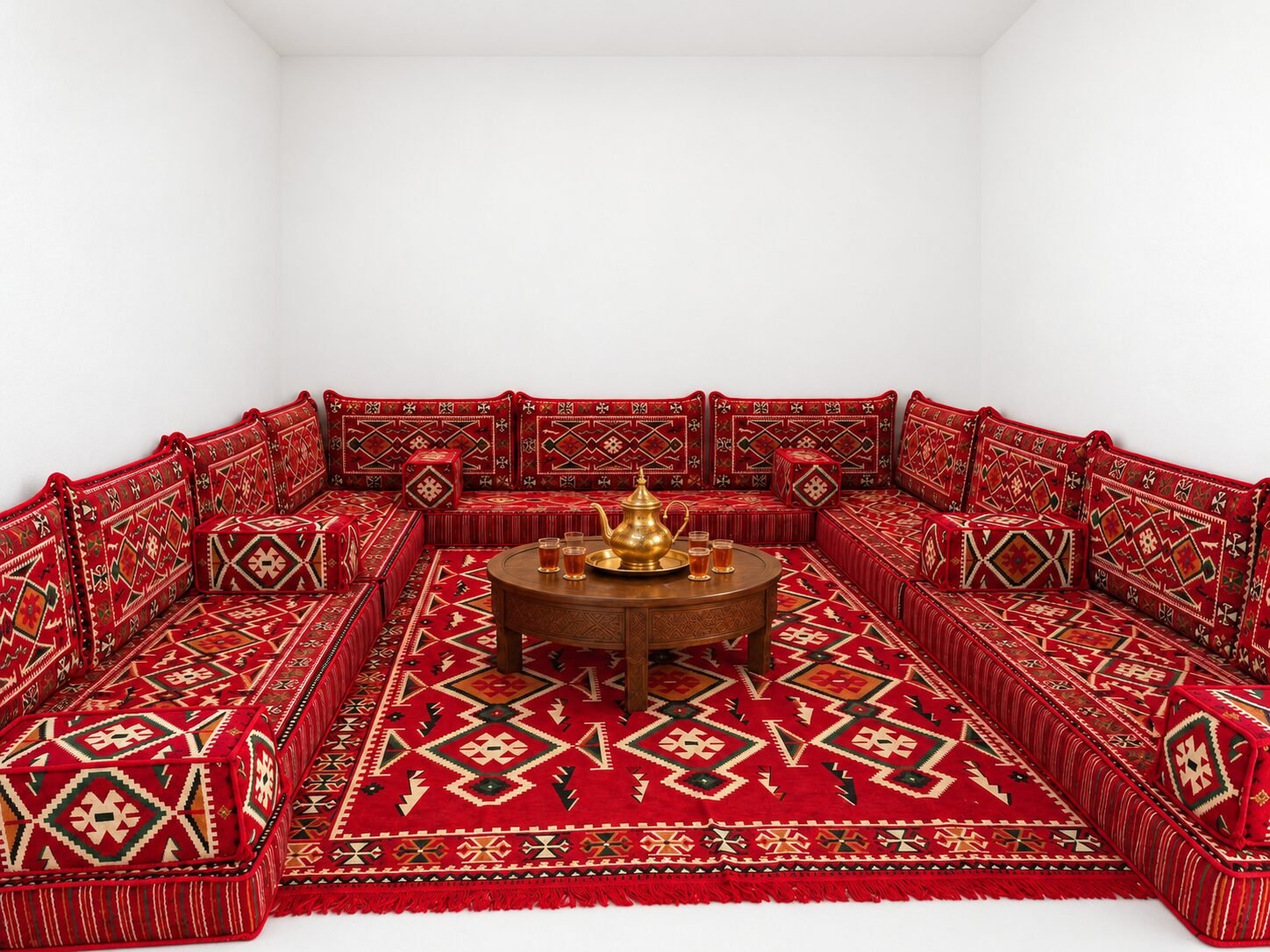 Crimson Sahrawi majlis seating in a white room
