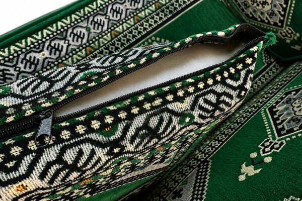 Close-up of the emerald green Sahrawi fabric with ivory motifs