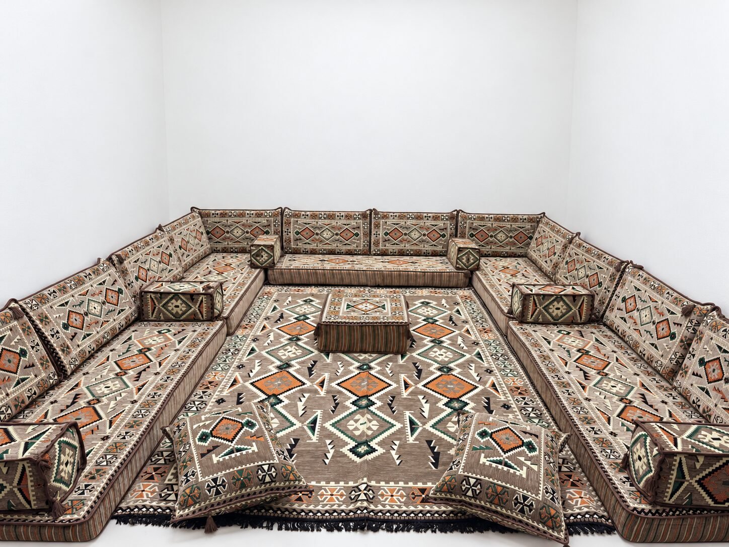 Tiris sand beige Sahrawi majlis with matching rug in a white room