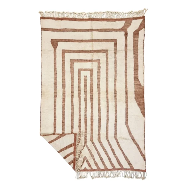 Ivory wool rug on a white background with terracotta lines forming nested rectangles and diagonal stripes, with a folded corner.