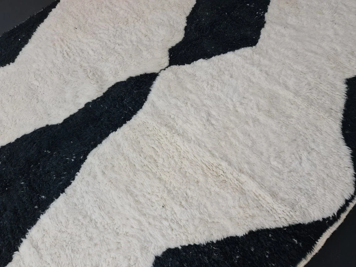 Close-up of shaggy ivory pile between large black diamond shapes.