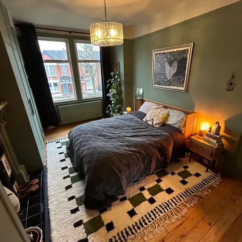 A handwoven Moroccan rug in a bedroom.