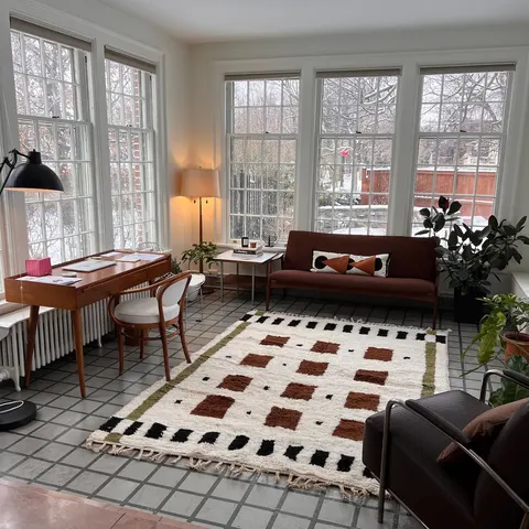 A handwoven Moroccan rug in a home office.