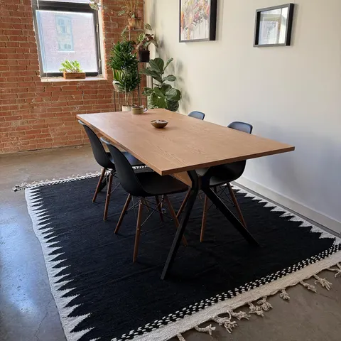 A handwoven Moroccan rug in a dining room.
