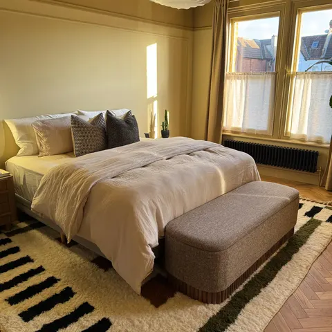 A handwoven Moroccan rug in a bedroom.