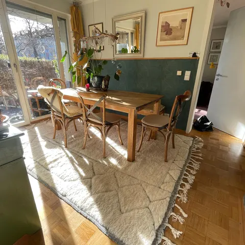 A handwoven Moroccan rug in a dining room.