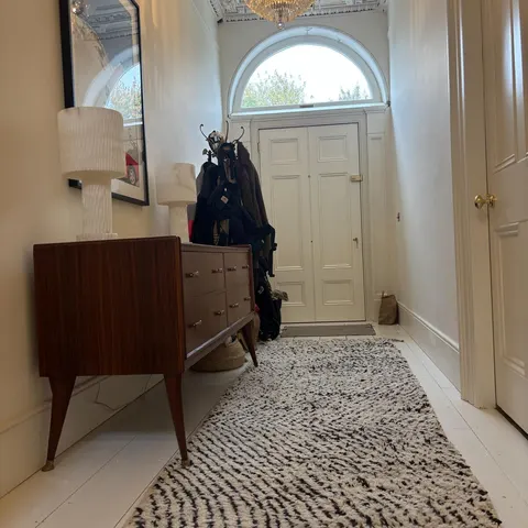 A handwoven Moroccan rug in a hallway.