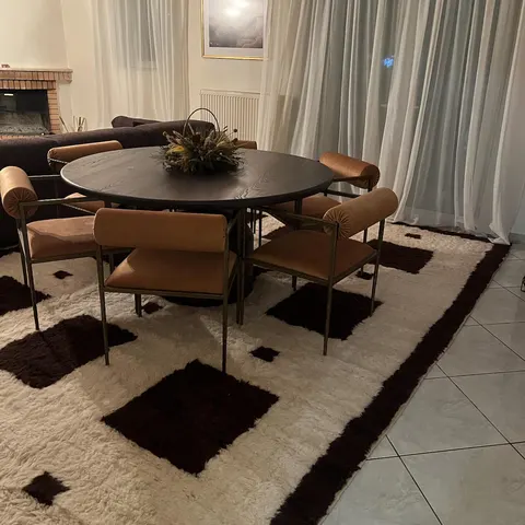 A handwoven Moroccan rug in a dining room.