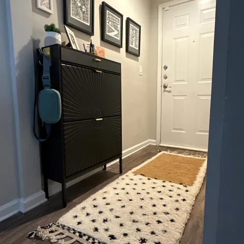 A handwoven Moroccan rug in a entryway.